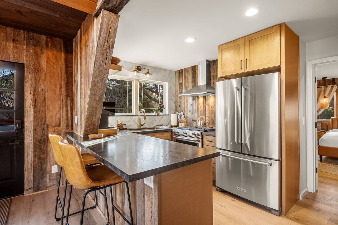 Kitchen with obsidian counters and leather bar stools