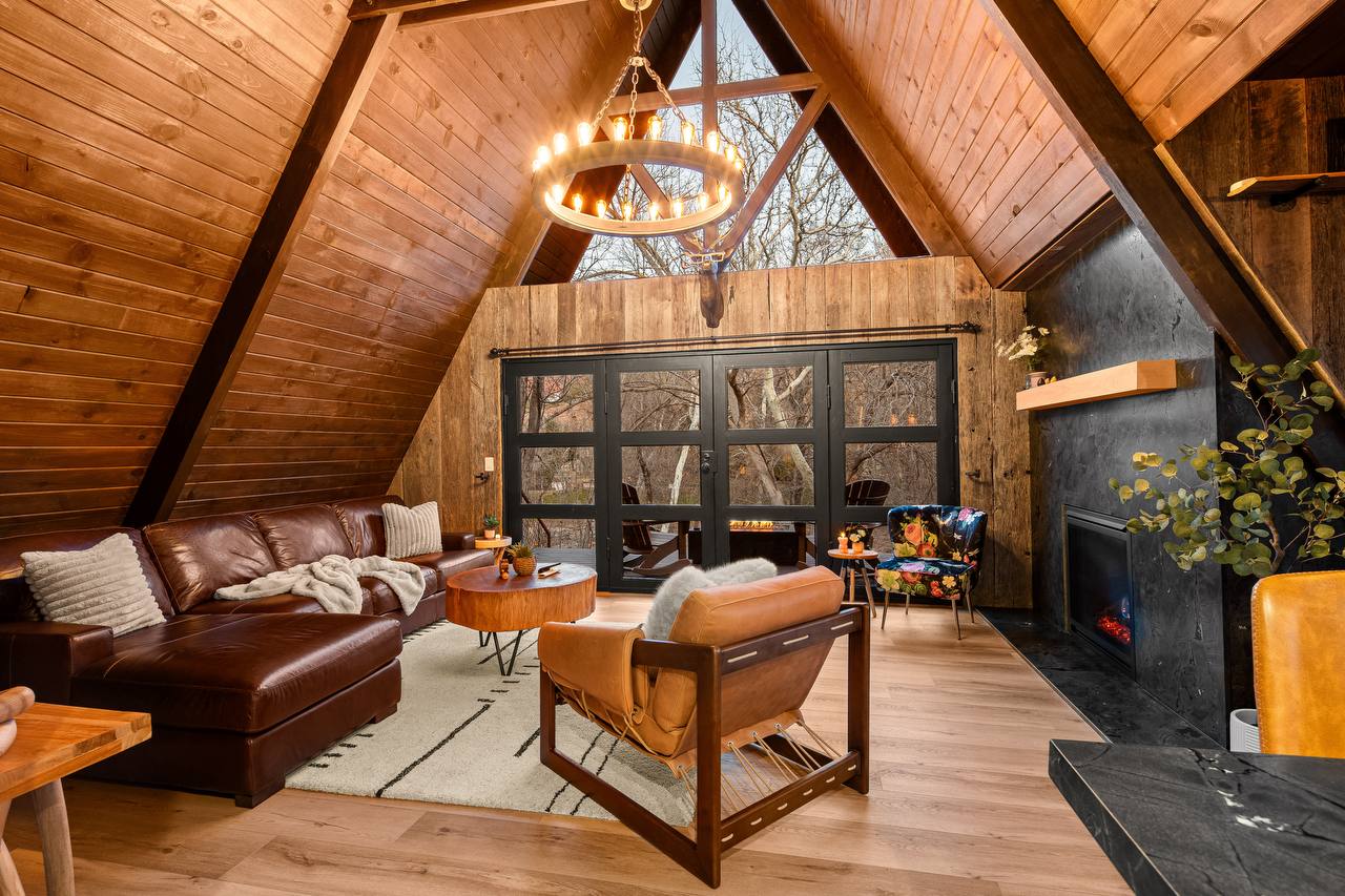 Living room with leather furniture and A-frame ceiling
