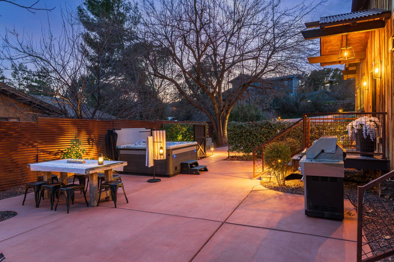 Hot tub and outdoor dining area at twilight