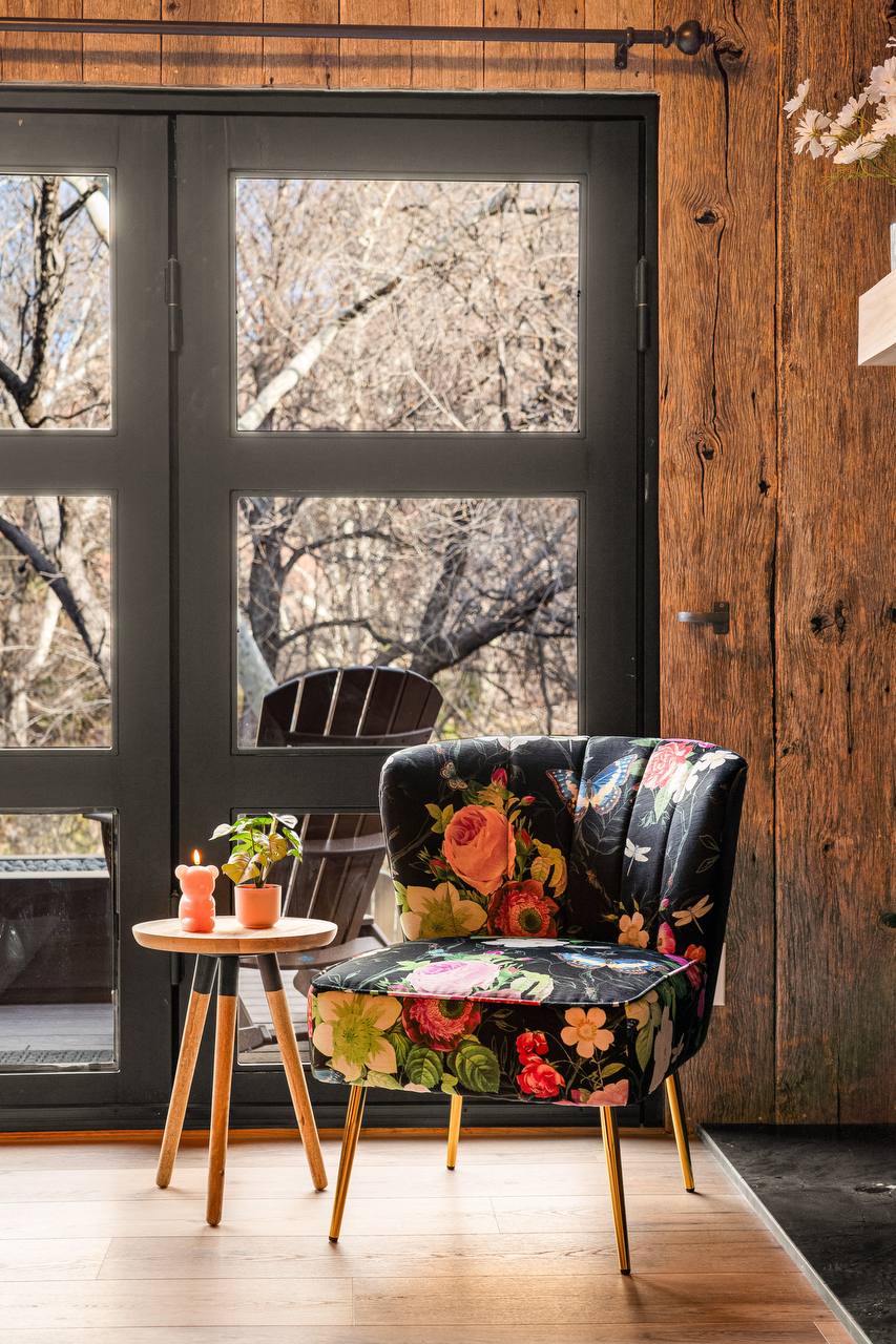 Floral accent chair with candles by the French doors